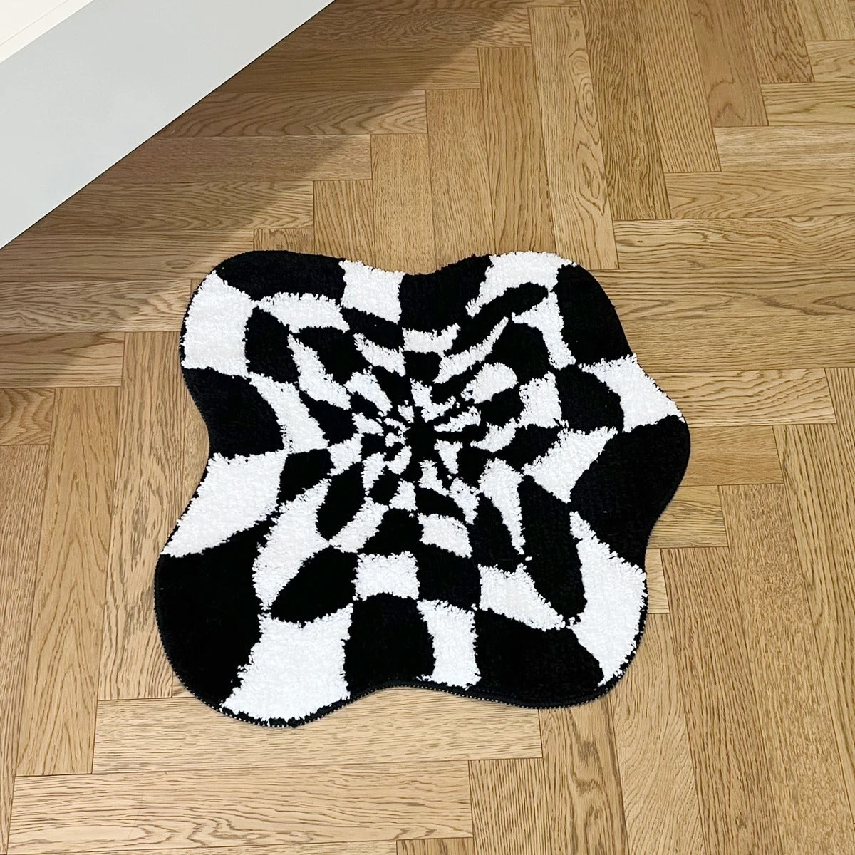 Black and white wavy checkered tufted rug with optical illusion pattern