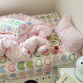 bedding set with pink comforter and heart-patterned sheets in y2k aesthetic