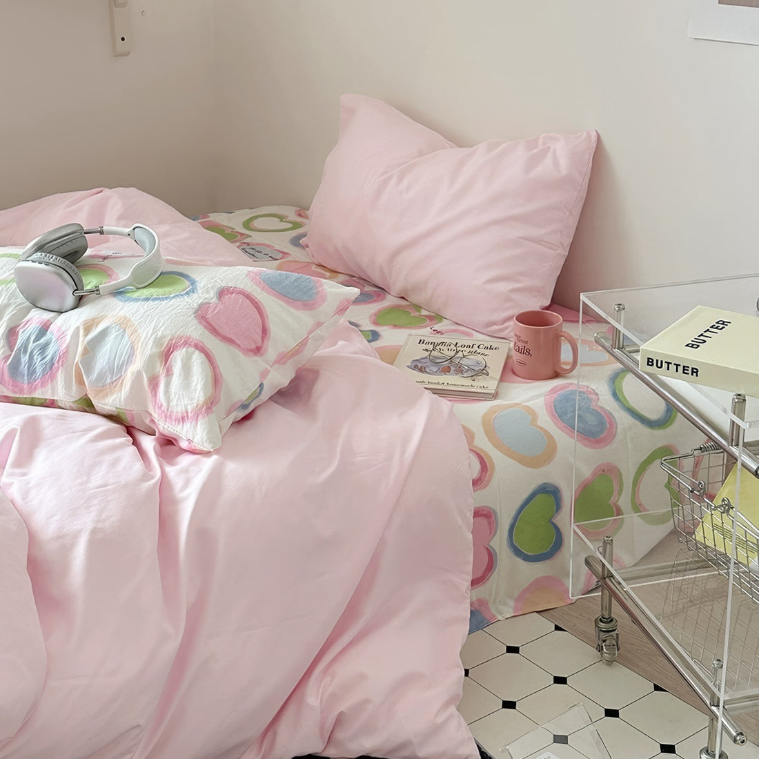 bedding set with pink comforter and heart-patterned sheets in y2k aesthetic
