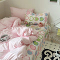 bedding set with pink comforter and heart-patterned sheets in y2k aesthetic
