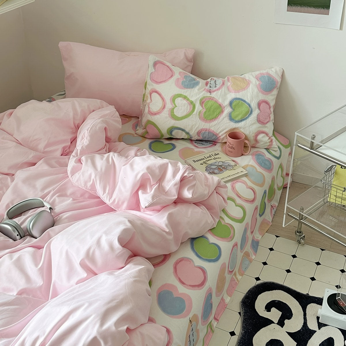 bedding set with pink comforter and heart-patterned sheets in y2k aesthetic